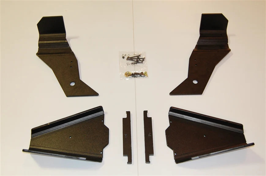 Four black metal brackets and two small rectangular metal pieces are arranged on a white surface with a plastic bag of screws, appearing as an assembly kit for the Trail Armor Can Am Commander iMpact A-Arm CV Front & Rear Trailing Boot Guards.